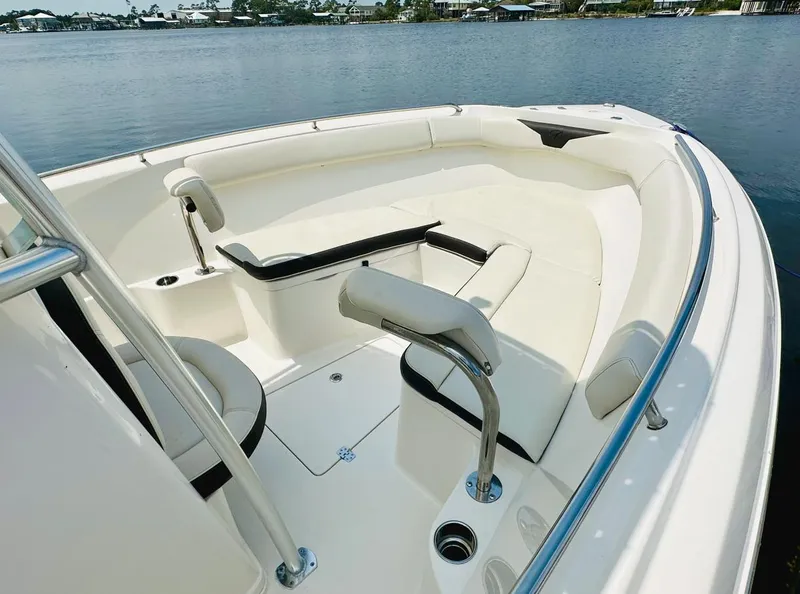 Slide: The Image of 2022 Sailfish 242 CC boat interior with white seating and stainless steel railings. - 9