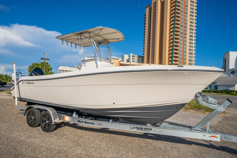 The Image of 2022 Cobia 237 Center Console boat on water with scenic background. - 0