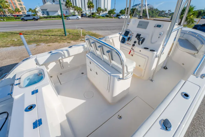 Slide: The Image of 2022 Cobia 237 CC boat interior with seating, console, and storage compartments. - 18