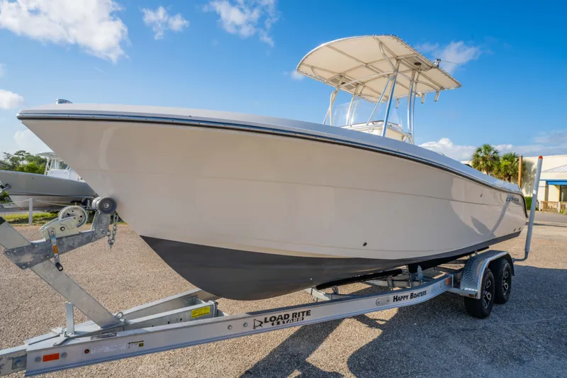 Slide: The Image of 2022 Cobia 237 Center Console boat with stylish geometric deck design. - 6