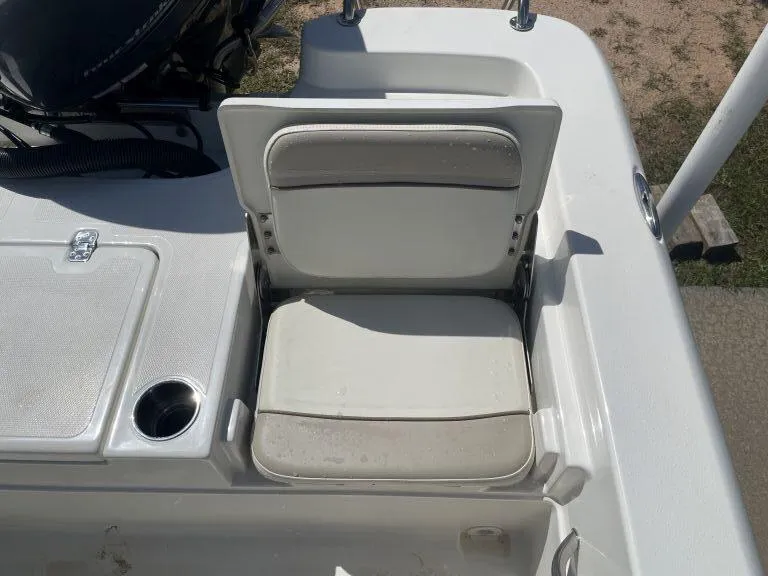 Slide: The Image of 2015 NauticStar 2200 Sport boat seat with cup holder and storage compartment. - 10