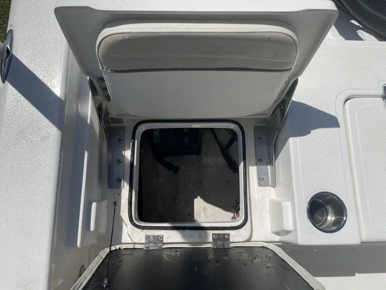 Slide: The Image of Open storage compartment on a 2015 NauticStar 2200 Sport boat. - 13
