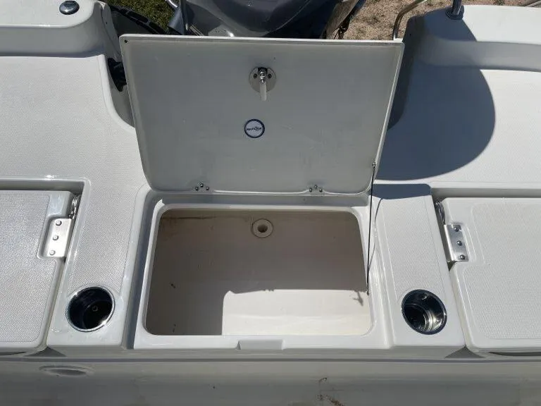 Slide: The Image of Open storage compartment on a 2015 NauticStar 2200 Sport boat deck. - 14