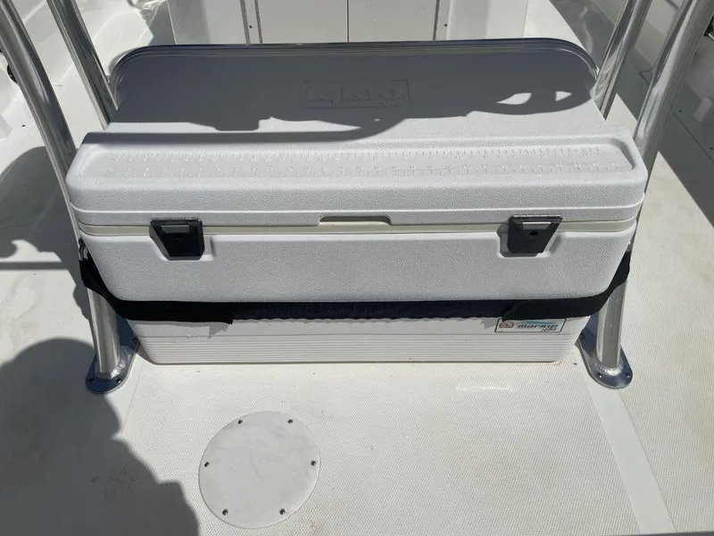 Slide: The Image of White cooler secured on a 2015 NauticStar 2200 Sport boat deck. - 15