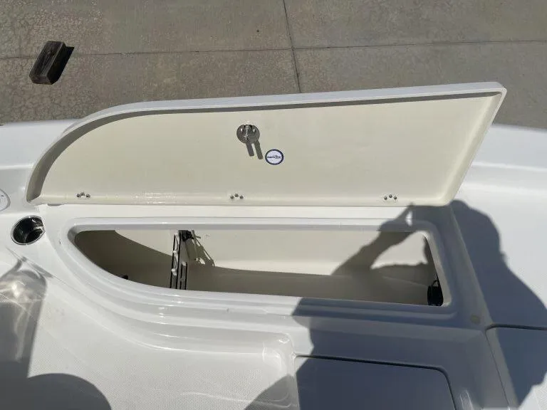 Slide: The Image of Open storage compartment on a 2015 NauticStar 2200 Sport boat. - 16