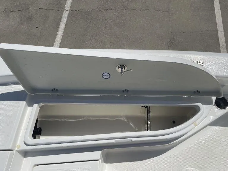 Slide: The Image of Open storage compartment on a 2015 NauticStar 2200 Sport boat. - 17