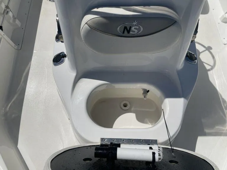 Slide: The Image of 2015 NauticStar 2200 Sport boat interior with seating and storage compartment. - 18