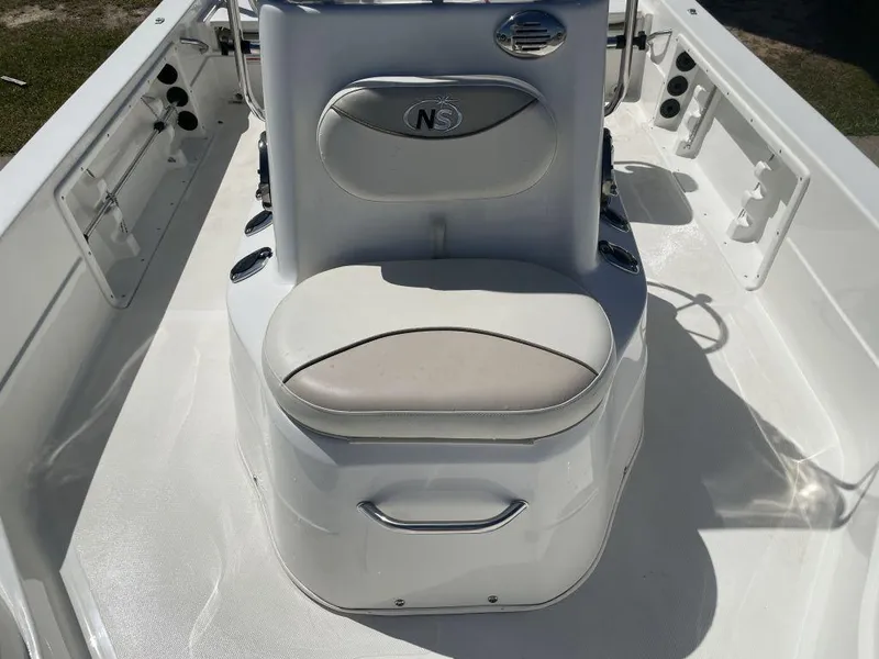 Slide: The Image of 2015 NauticStar 2200 Sport boat interior with cushioned seating and storage. - 19