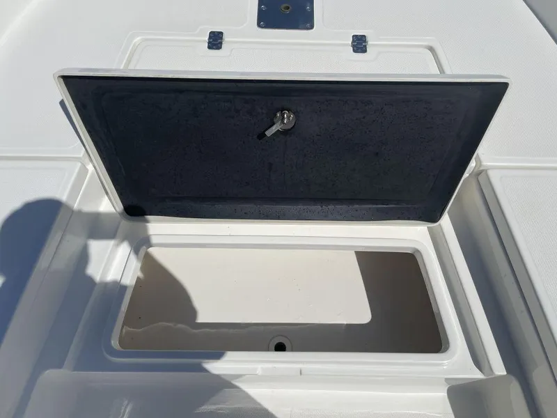 Slide: The Image of Open storage compartment on 2015 NauticStar 2200 Sport boat deck. - 20