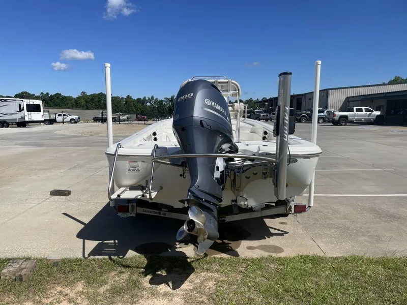 Slide: The Image of 2015 NauticStar 2200 Sport boat with Yamaha engine in parking lot. - 4