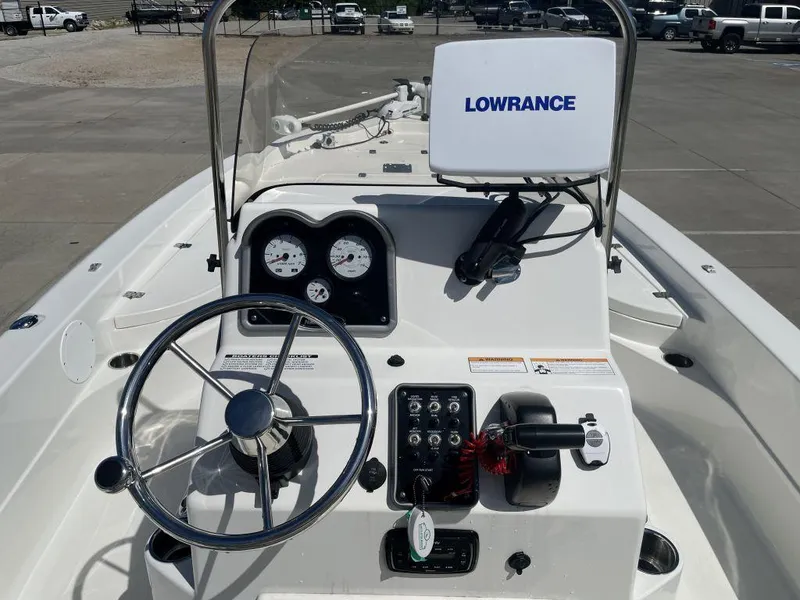 Slide: The Image of 2015 NauticStar 2200 Sport boat dashboard with steering wheel and Lowrance navigation system. - 6