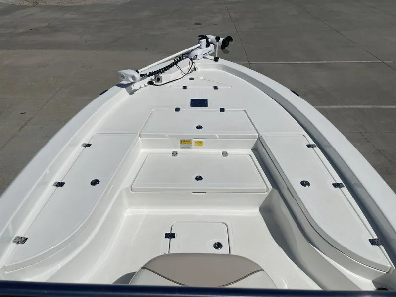 Slide: The Image of 2015 NauticStar 2200 Sport boat deck with storage compartments and trolling motor. - 8