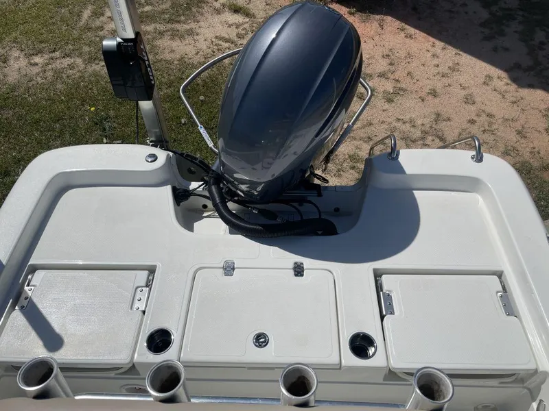 Slide: The Image of 2015 NauticStar 2200 Sport boat's rear deck with motor and storage compartments. - 9