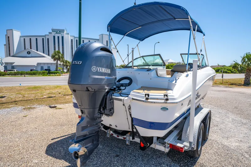 Slide: The Image of 2020 NauticStar 203 DC boat with Yamaha engine on trailer, parked outdoors. - 10