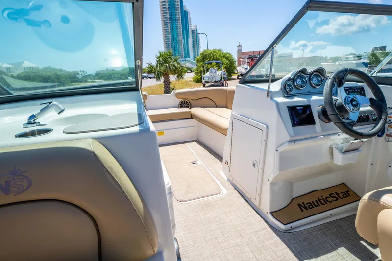 Slide: The Image of 2020 NauticStar 203 DC boat interior with modern dashboard and seating. - 16