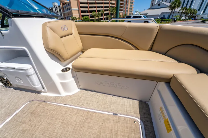 Slide: The Image of 2020 NauticStar 203 DC boat interior with beige seating and cup holder. - 21