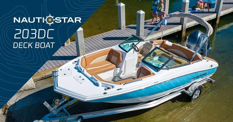 Slide: The Image of 2020 NauticStar 203 DC deck boat on trailer by dock. - 22