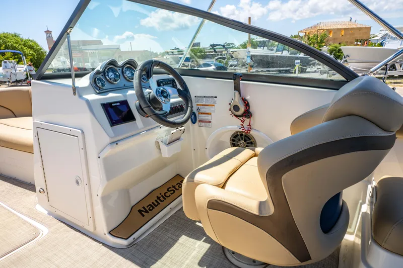 Slide: The Image of 2020 NauticStar 203 DC boat interior with steering wheel and dashboard controls. - 6