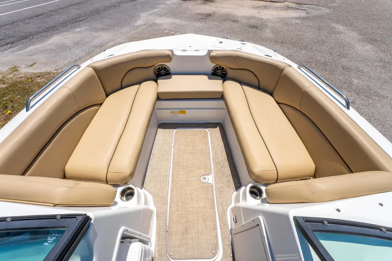 Slide: The Image of 2020 NauticStar 203 DC boat interior with tan seating and spacious layout. - 9