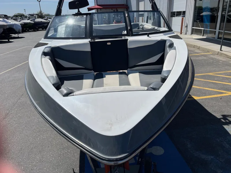 Slide: The Image of 2021 Axis T22 boat with sleek design and spacious seating, parked outdoors. - 13