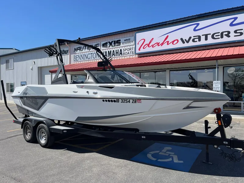 Slide: The Image of 2021 Axis T22 boat on trailer outside Idaho Watersports dealership. - 14