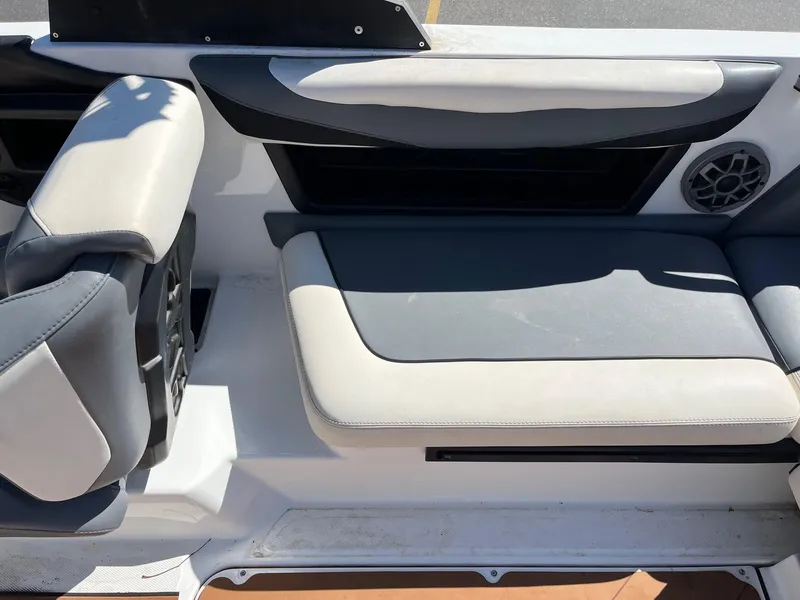 Slide: The Image of Interior seating of a 2021 Axis T22 boat, featuring gray and white upholstery. - 21