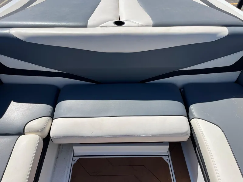 Slide: The Image of 2021 Axis T22 boat interior seating with gray and white upholstery. - 23