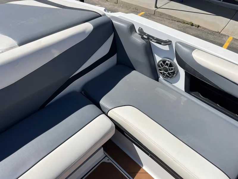 Slide: The Image of 2021 Axis T22 boat interior with gray and white seating, speaker, and handle. - 24