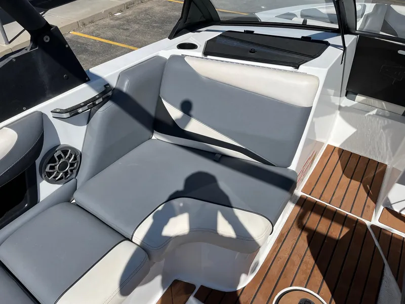 Slide: The Image of 2021 Axis T22 boat interior with gray seating and wood flooring. - 26