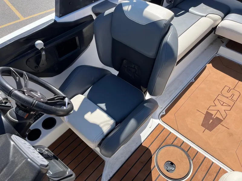Slide: The Image of 2021 Axis T22 boat interior with steering wheel, seating, and branded flooring. - 28