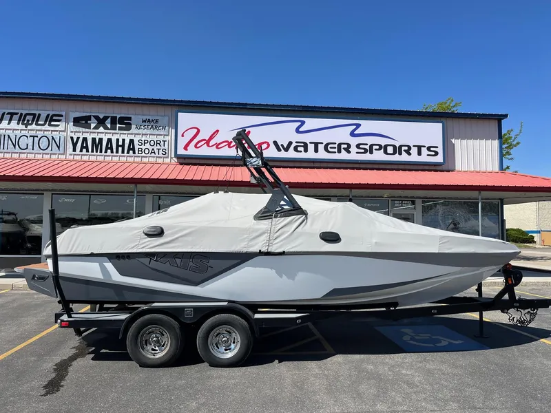 Slide: The Image of 2021 Axis T22 boat covered, parked outside Idaho Water Sports store. - 3