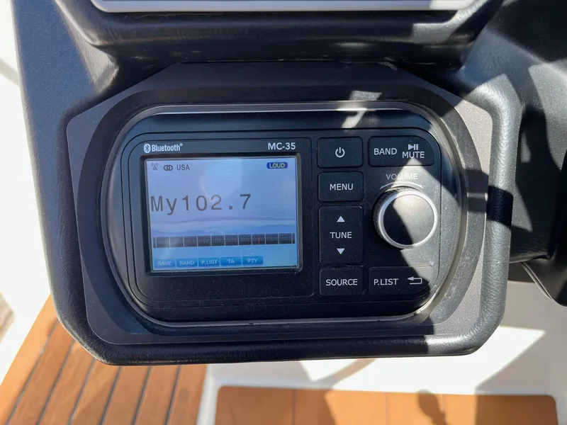 Slide: The Image of Boat stereo system displaying radio station My102.7, featuring Bluetooth connectivity. - 32
