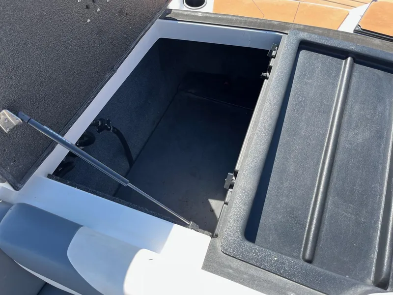 Slide: The Image of Open storage compartment of 2021 Axis T22 boat, showing interior space. - 33