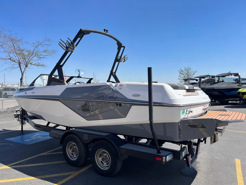 Slide: The Image of 2021 Axis T22 boat on trailer under clear blue sky. - 8