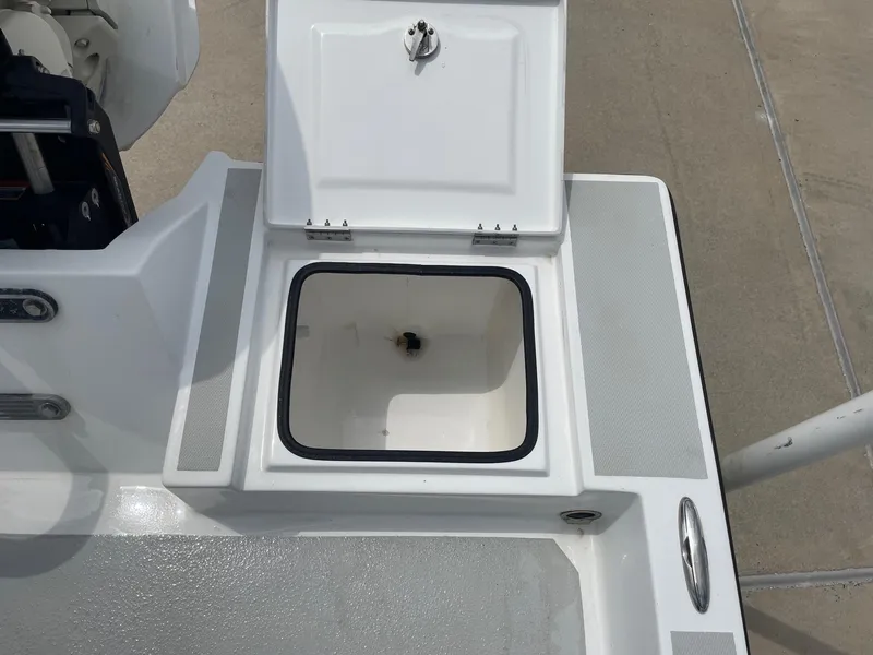 Slide: The Image of Open storage compartment on a 2020 Shallow Sport 18 Sport boat. - 16