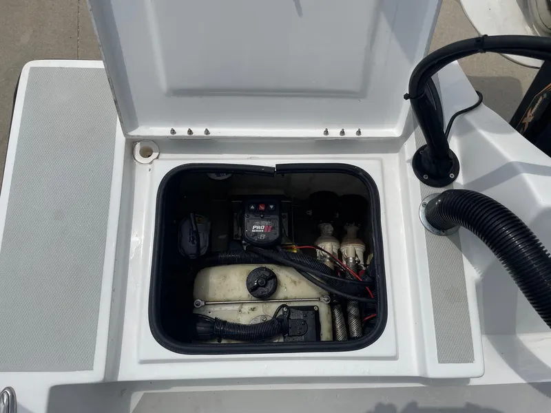 Slide: The Image of Open hatch of 2020 Shallow Sport 18 Sport boat showing internal components and wiring. - 17