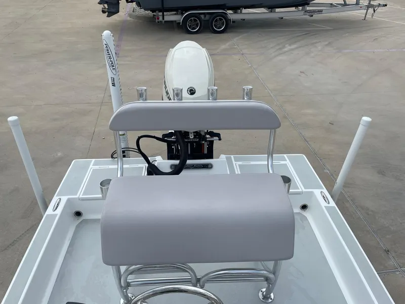 Slide: The Image of 2020 Shallow Sport 18 Sport boat with motor and seating, parked on concrete. - 18