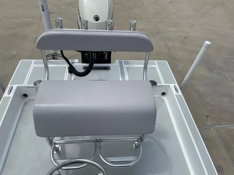 Slide: The Image of 2020 Shallow Sport 18 Sport boat with gray seating and steering wheel. - 19