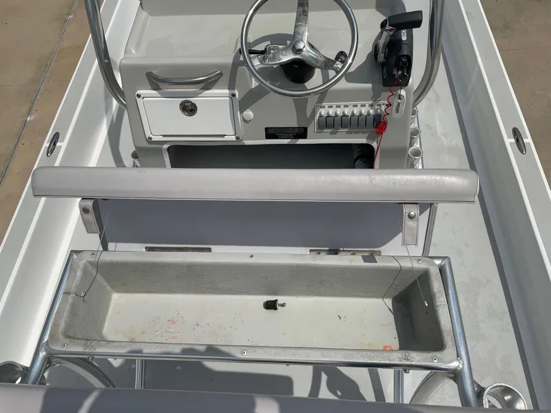 Slide: The Image of 2020 Shallow Sport 18 Sport boat interior with steering wheel and seating area. - 20