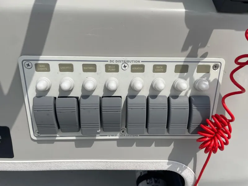 Slide: The Image of Control panel of a 2020 Shallow Sport 18 Sport boat with labeled switches. - 21