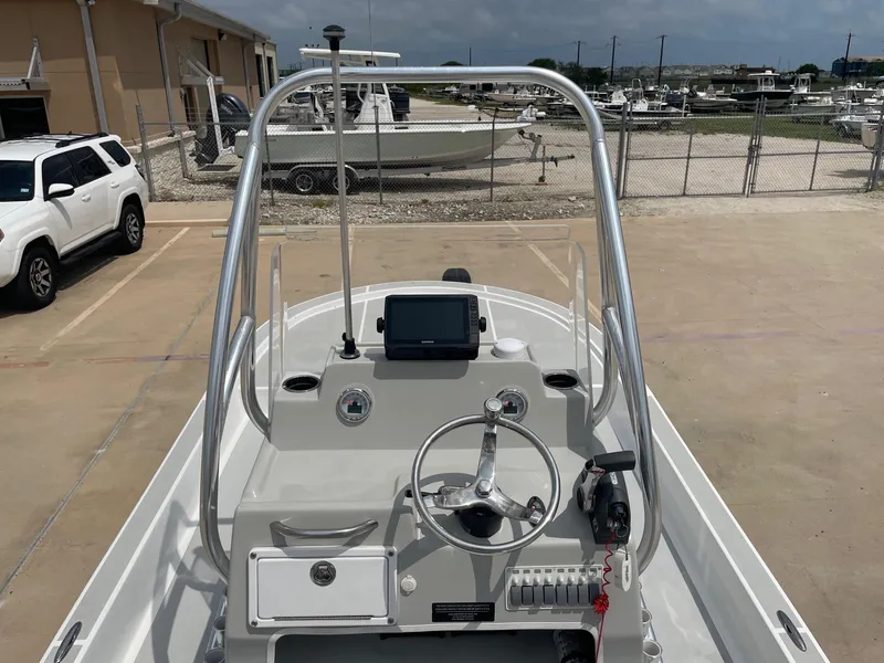 Slide: The Image of 2020 Shallow Sport 18 Sport boat dashboard with steering wheel and navigation equipment. - 24