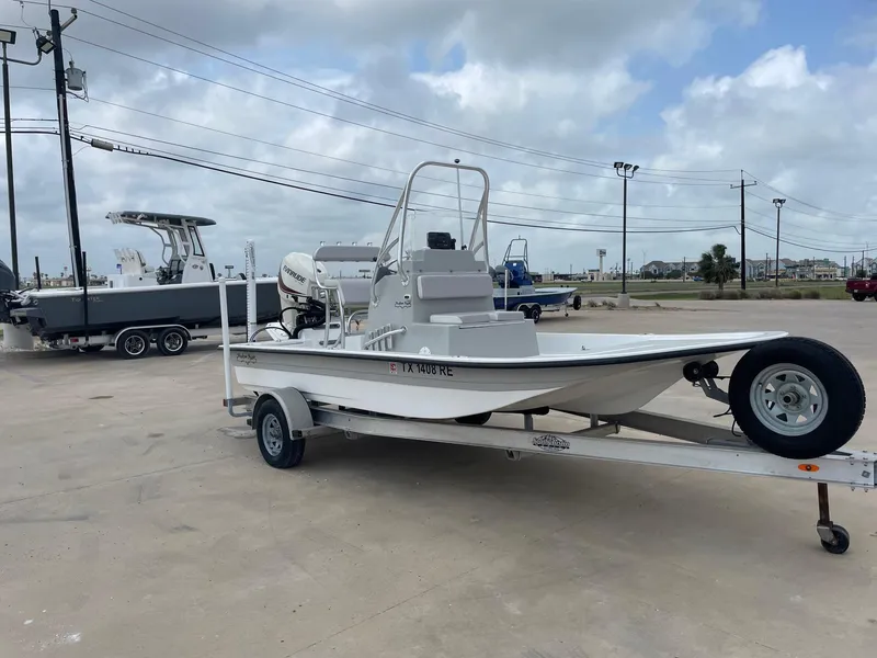 Slide: The Image of 2020 Shallow Sport 18 Sport boat on trailer, parked outdoors under cloudy sky. - 7