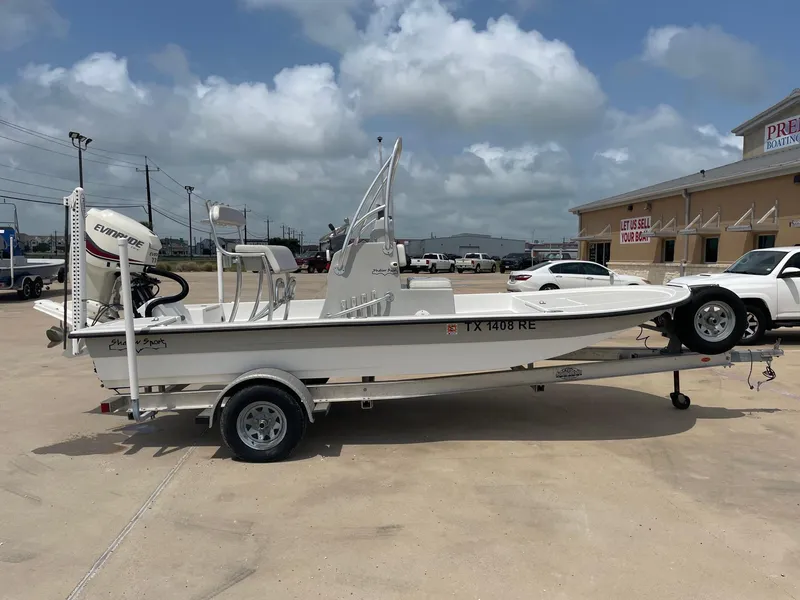 Slide: The Image of 2020 Shallow Sport 18 Sport boat on trailer, parked outdoors under cloudy sky. - 8