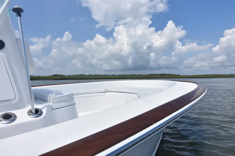 Slide: The Image of 2013 Chaos 21 Tarpon Bay boat on calm water under a cloudy sky. - 14