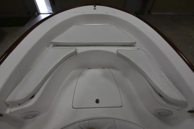 Slide: The Image of 2013 Chaos 21 Tarpon Bay boat interior with white cushioned seating. - 18