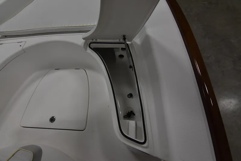 Slide: The Image of 2013 Chaos 21 Tarpon Bay boat storage compartment, open lid, white interior. - 19