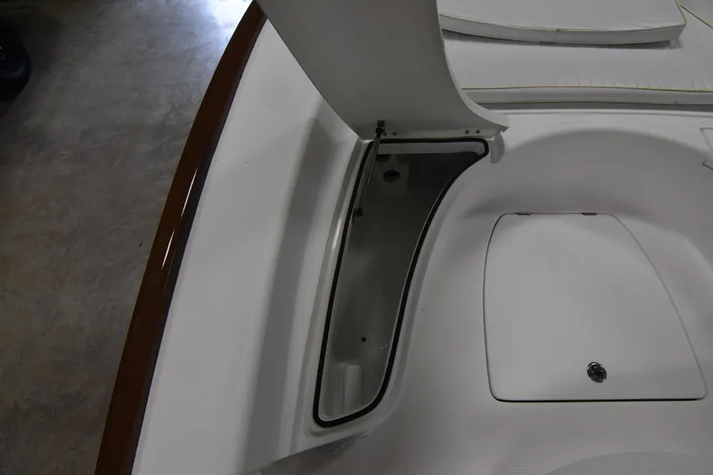 Slide: The Image of 2013 Chaos 21 Tarpon Bay boat storage compartment, open lid, white interior. - 20