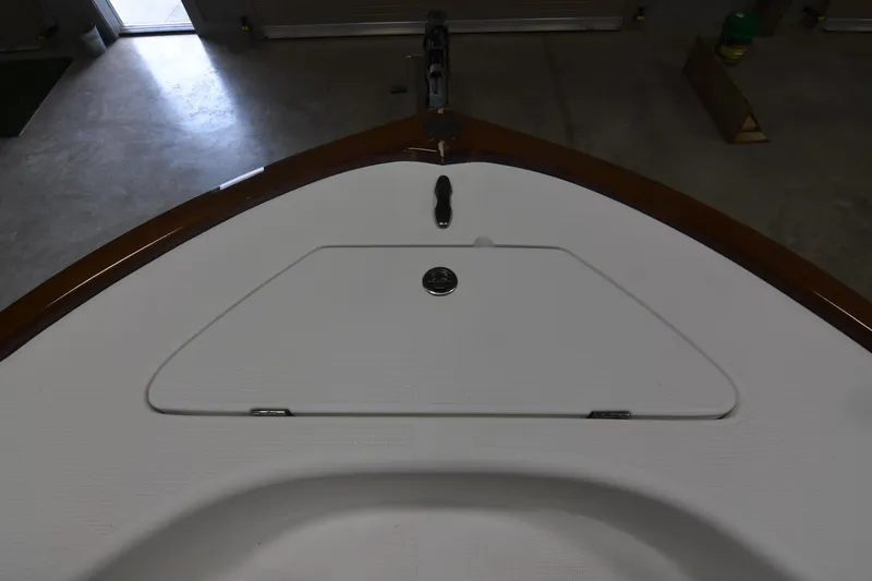 Slide: The Image of 2013 Chaos 21 Tarpon Bay boat deck with storage compartment, viewed indoors. - 22