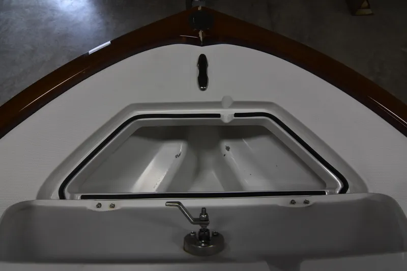 Slide: The Image of 2013 Chaos 21 Tarpon Bay boat interior with storage compartment and latch. - 23