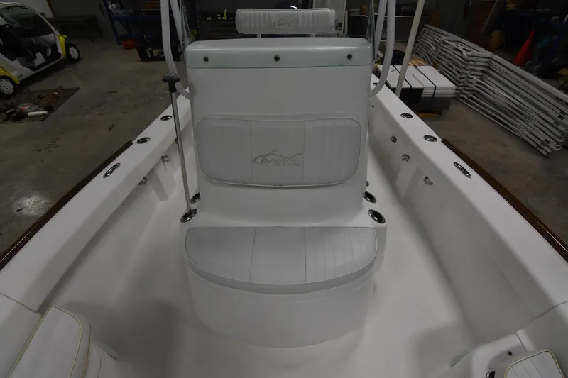 Slide: The Image of 2013 Chaos 21 Tarpon Bay boat interior with white seating and console. - 27